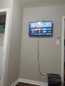 a flat screen tv hanging on a wall at Anne room A in Irvington