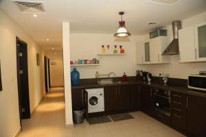 a kitchen with a washer and a washing machine at Apartment Samarah Resort D44 at DeadSea, Sea & Pool view-Families & couples only in Sowayma