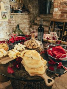 a table with a bunch of cheese and wine glasses at Al Silter in Capriate San Gervasio