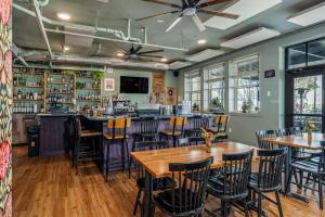 a bar with wooden tables and chairs in a restaurant at Southern Blue in McMinnville