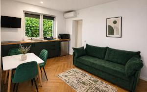 a living room with a green couch and a table at Arena Park in Bucharest