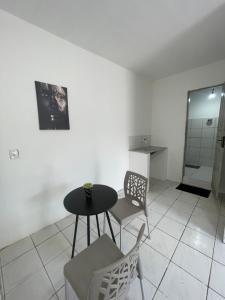 a dining room with a table and chairs in a room at Hospedagem Sousa in Santa Inês +2 photos