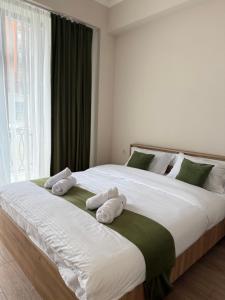 a bedroom with two beds with towels on them at N4 Alvina Complex in Tsaghkadzor
