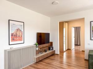a living room with a radiator and a television at Modern Spacious Mountain View Apt in Braşov