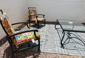 two chairs and a glass table on a patio at Casa Diego in La Paz +10 photos
