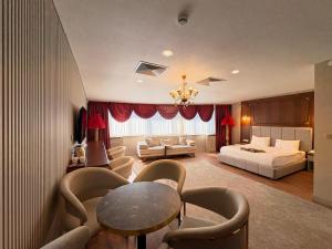 a hotel room with a bed and a table and chairs at Volonte Hotel & Spa in Bahçelievler