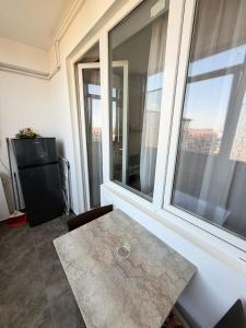 a living room with a table and a large window at RC RelaxApart 820 in Dudu