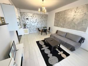 a living room with a couch and a table at RC RelaxApart 820 in Dudu