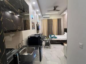 a small room with a sink and a bed at Sukoon studios in Ghaziabad