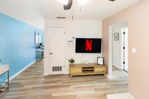 an empty living room with a tv on a wall at Pet Friendly Stylish Condo Near Campus in Gainesville