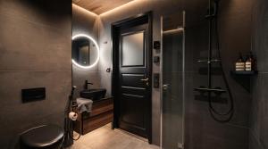 a bathroom with a black door and a sink at Levi Nordic Star Igloos in Levi +15 photos