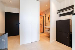 a room with white walls and a black closet at Suite luxe jacuzzi - CANNES SUQUET in Cannes