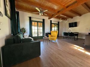 a living room with a couch and a table at Green river cottage in Žažina
