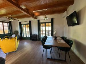 a living room with a dining room table and chairs at Green river cottage in Žažina +14 photos