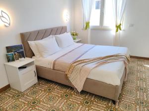 a bedroom with a large bed and a window at Home Julia in Massa Lubrense
