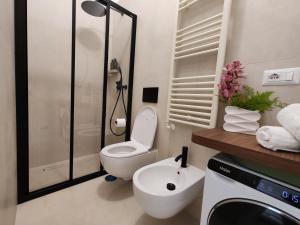 a bathroom with a toilet and a sink and a shower at Home Julia in Massa Lubrense