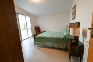a bedroom with a bed and a lamp on a table at Casa La Pigna in Lucito