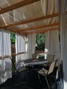a patio with a table and chairs under awning at Camp Phoenix in Srima +20 photos