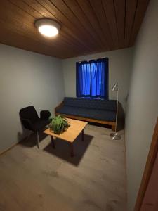 a bedroom with a bed and a table and a chair at Rena Hostel in Rena