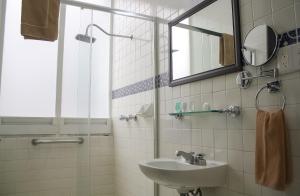 a bathroom with a sink and a mirror at Hotel Casino Morelia in Morelia +45 photos