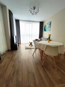 a living room with a table and a couch at Apartment in Chantrer Residence with garage in Burgas