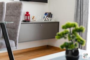 a living room with a plant and a shelf at Lepi Jova SNEZNIK in Vrnjačka Banja