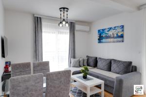 a living room with a couch and a table at Lepi Jova SNEZNIK in Vrnjačka Banja
