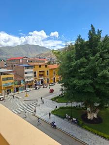 a view of a town with a tree and buildings at Hotel las vegas in Huánuco