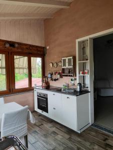 a kitchen with white cabinets and a counter top at Agriturismo Tenuta Blueberry - Glicine in Varallo Pombia +32 photos