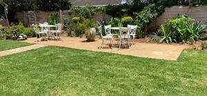 a group of chairs sitting on a patio in a yard at Highway Haven in Stilfontein