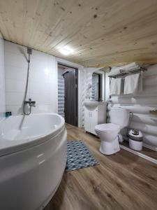 a bathroom with a white tub and a toilet at Отель MONBLAN in Yablunytsya +32 photos