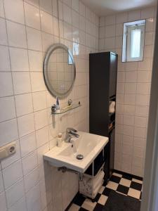 a bathroom with a sink and a mirror at De Posthoorn in Appelscha +41 photos