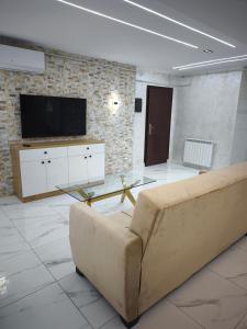 a living room with a couch and a tv at studio moderne in Tizi Ouzou