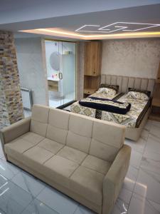 a living room with two beds and a couch at studio moderne in Tizi Ouzou