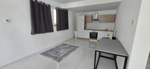 a white room with a table and a kitchen at Das Haus in Furth an der Triesting +23 photos