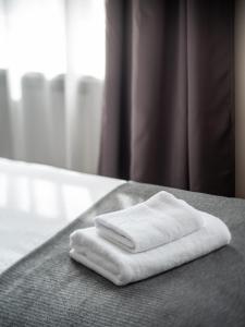 a stack of white towels sitting on a table at M6 Rooms Riga in Riga +122 photos