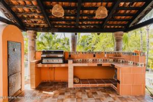 an outdoor kitchen with a grill in a house at Casa Virgilio B&B in Nuevo Vallarta