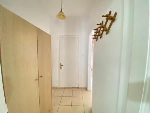 an empty hallway with a white room with a door at Ravanos Apartment in Loutraki