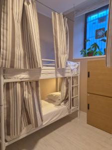 two bunk beds in a room with a window at Zippy Hostel in Milan