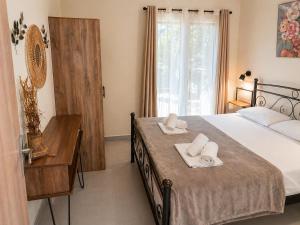 a bedroom with a bed with two towels on it at Joannas Luxury Apartment in Corfu