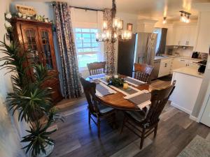 a kitchen and dining room with a table and chairs at By Summersville Lake 3BR Jetted Tub Sauna in Craigsville