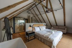 a bedroom with a large bed and a bath tub at River House Lodge in Malelane +76 photos