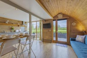 a kitchen and living room with a blue couch at 1 Bed in Barnacre oc-b34349 in Catterall