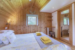 a bedroom with a bed with yellow towels on it at 1 Bed in Barnacre oc-b34349 in Catterall