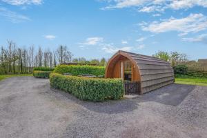 a small wooden shed in a yard with bushes at 1 Bed in Barnacre oc-w34347 in Catterall