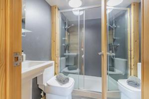 a bathroom with a toilet and a glass shower at 1 Bed in Barnacre oc-b34349 in Catterall +12 photos