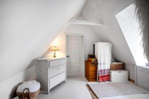 a attic room with a dresser and a refrigerator at AE326-Marstal-Pers-Bro-6 in Marstal