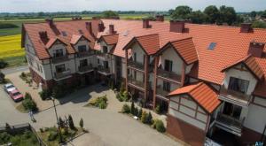 an overhead view of a row of houses with orange roofs at Mierzeja Bliss Point - Basen, Parking, Grill in Sztutowo