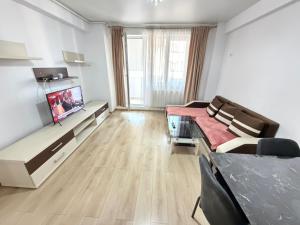 a living room with a tv and a couch at RC RelaxApart 602 in Dudu