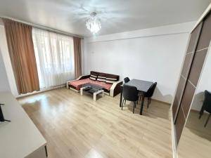 a living room with a couch and a table at RC RelaxApart 602 in Dudu +7 photos